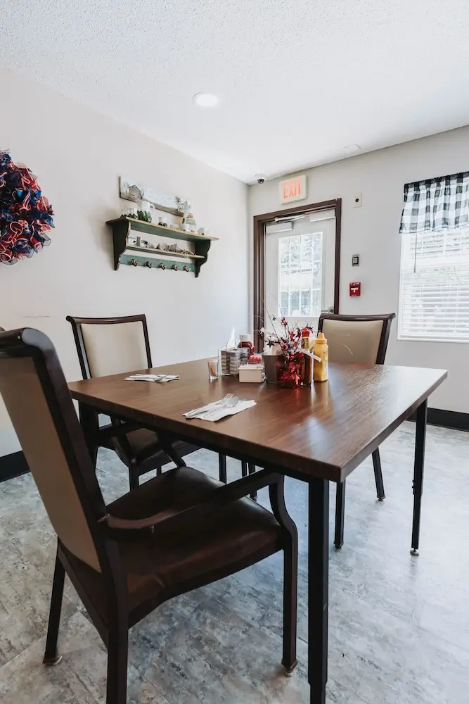 Dining table for four in a bright room at French Meadow Place
