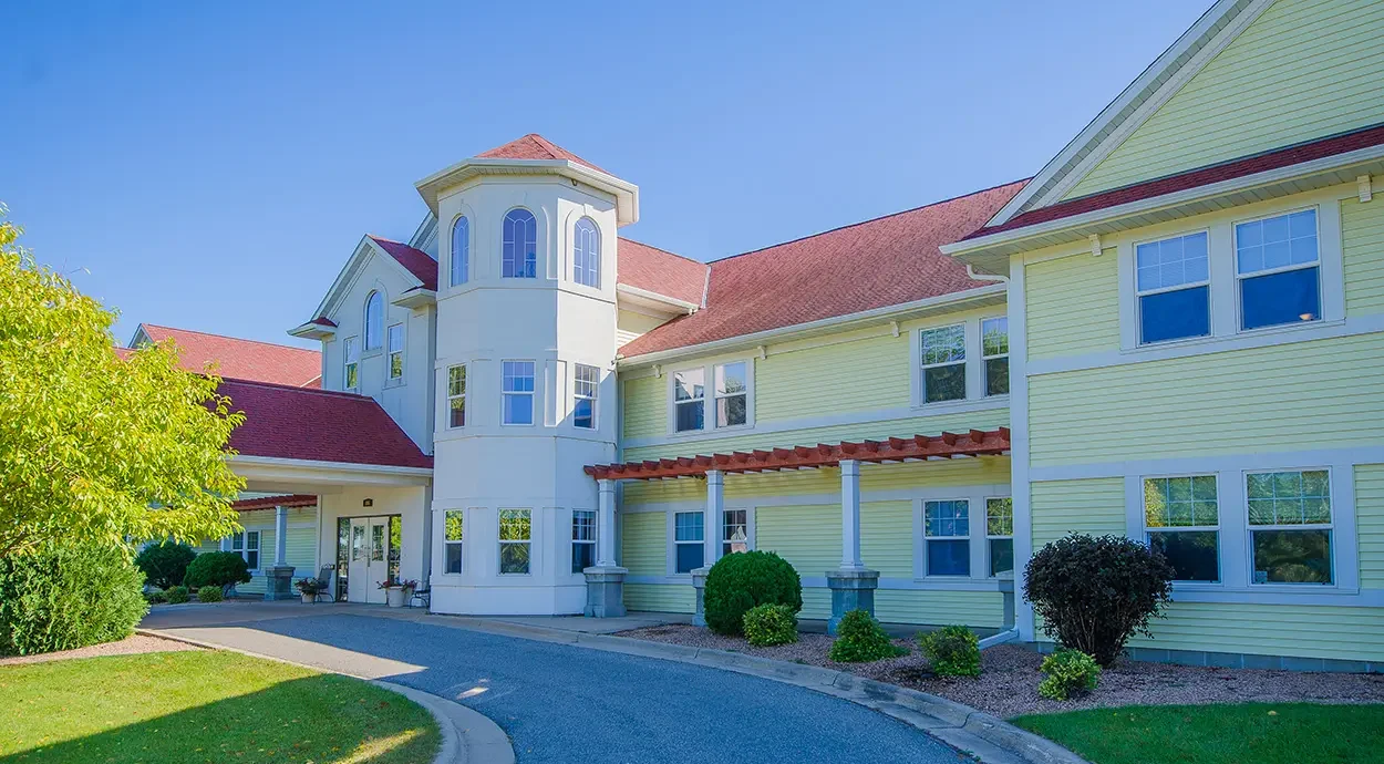 Entrance drive and turret at French Meadow Place under a blue sky