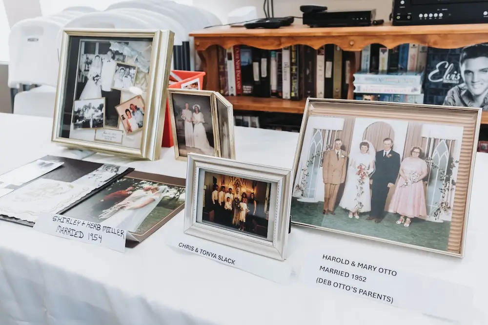 Framed family wedding photos displayed on a table at French Meadow Place