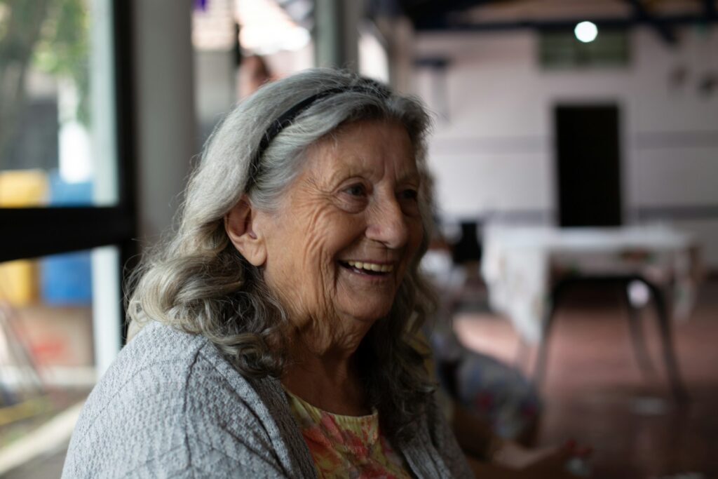 An older woman smiling in conversation